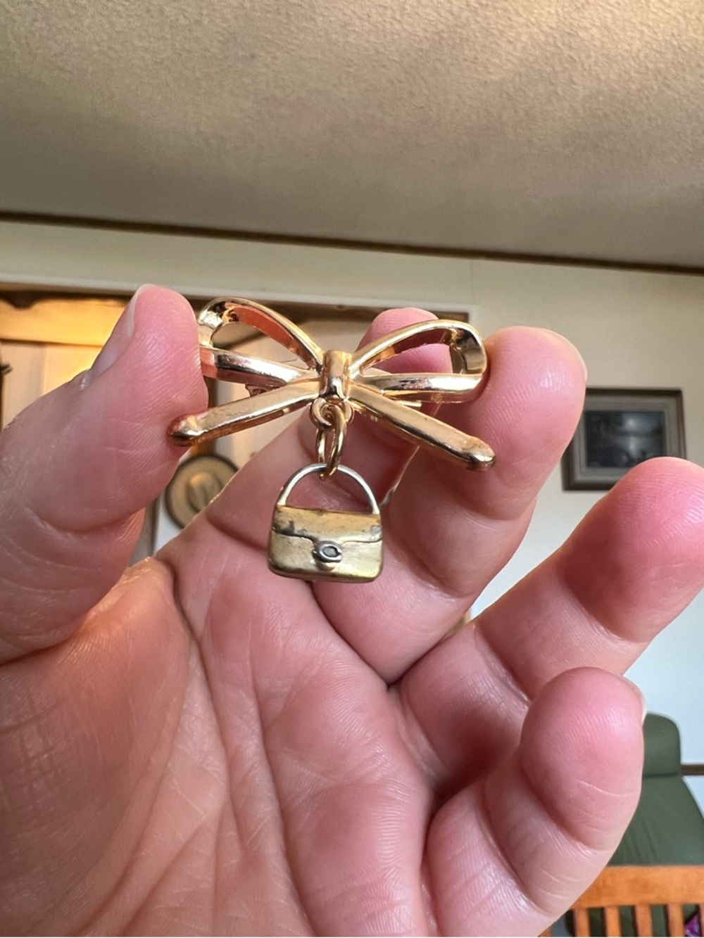 Coach Tabby Charm in a Gold Bow brooch